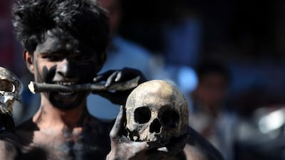 A Hindu devotee holds a human skull and bone during a procession for Maha Shivaratri, dedicated to the Hindu god Lord Shiva, in Allahabad. Sanjay Kanojia / AFP