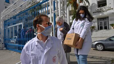 Emergency doctors and nurses, who have been trained to handle coronavirus disease cases, exit the Tunisian health ministry premises in the capital Tunis. AFP