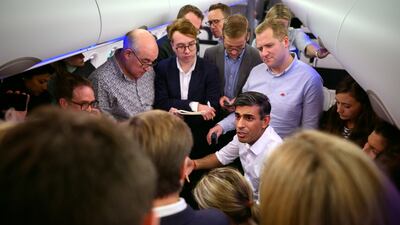 British Prime Minister Rishi Sunak holds a 'huddle' press conference with political journalists on board a plane heading for Bali. PA