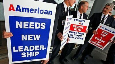 American Airlines pilots picket in September. American has negotiated new, lower-cost contracts with all its unions. Tim Boyle / Bloomberg News