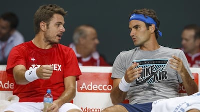 Stanislas Wawrinka, left, of Switzerland, and Roger Federer, right, of Switzerland, speak together during a training session of the Swiss Davis Cup tennis team prior to the Davis Cup World Group quarterf-inal match between Switzerland and Kazakhstan, in Geneva, Switzerland, on Wednesday. The match between Switzerland and Kazakhstan will take place from April 4 to April 6. Salvatore Di Nolfi / AP / Keystone / April 2, 2014