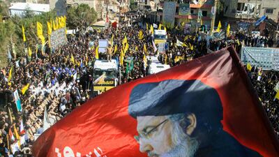 A flag bearing a portrait of assassinated Hezbollah leader Hassan Nasrallah at the funeral of 95 Hezbollah fighters and Lebanese civilians killed in Israeli air strikes, in the border town of Aitaroun. AFP