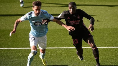 Real Madrid defender Ferland Mendy, right, and Celta Vigo's Brais Mendez battle for possession. AFP