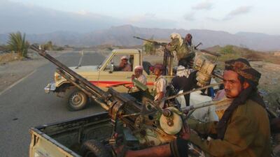 Resistance fighters loyal to the government of Yemeni president Abdrabu Mansur Hadi sit on the back of armed pick up trucks in Taez province's Al Wazeyah district on November 19, 2015. Pro-government forces halted their advance on all fronts in Taez a day later after the Houthis heavily mined roads to the provincial capital. Nabil Hassan/AFP Photo