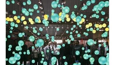Visitors watch a three dimensional presentation on cloud computing at a recent technology fair.