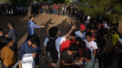 Refugees who arrive to Diyarbakir from Turkish-Iran border fight for donated food near intercity bus station in Diyarbakir, Turkey.