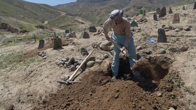 A man digs a grave for one of the 57 victims of a bomb blast before the burial a day after the attack on a voter registration centre in Kabul, on April 23, 2018. Shah Marai / AFP