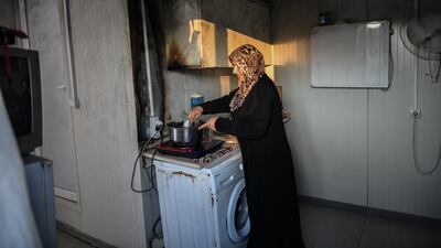 A Syrian woman cooks dinner in the camp. Getty Images