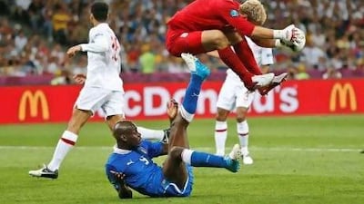 Joe Hart collects the ball ahead of Italy striker Mario Balotelli. The England goalkeeper had a busy evening at the Olympic Stadium in Kiev and was unable to prevent the Azzurri winning on penalties.