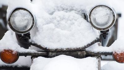 The snow covered headlights of a motorcycle let the vehicle appear to smile and enjoy the winterly weather conditions in Berlin, Germany. Lukas Schulze / EPA