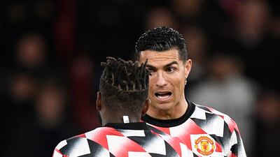 Manchester United's Portuguese striker Cristiano Ronaldo speaks to teammate Fred during the warm up. AFP