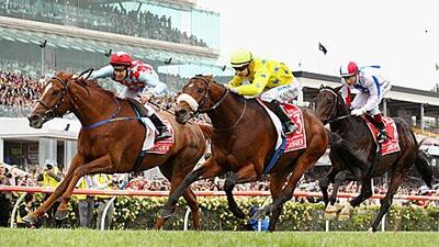 Christophe Lemaire, in the yellow silks, centre, rides Dunaden nose-to-nose with Red Cadeaux, left. Dunaden, the French horse, won the Melbourne Cup after a photo finish.
