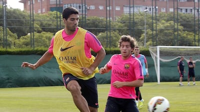Luis Suarez, left, is happy to be kicking a ball around with Sergi Roberto and his Barcelona teammates. Gustau Nacarino / Reuters