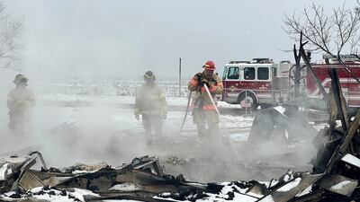 Firefighters extinguish a hot spot from the Smokehouse Creek fire in Stinnett, Texas. AP