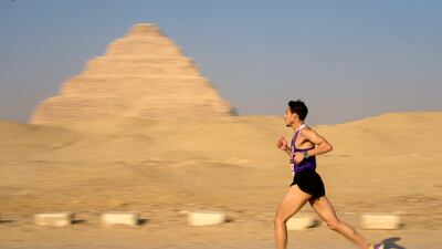 A runner passes a pyramid during the 10km race. AP