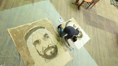 Sylvain Tremblay practising for his portrait of Sheikh Zayed created in sand. Courtesy Canadian University of Dubai