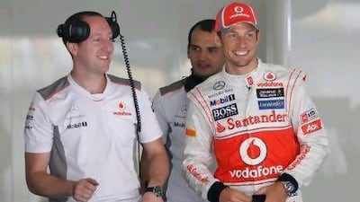 Jenson Button, right, chats with colleagues in the McLaren team garage.