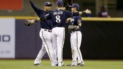 The Milwaukee Brewers’ Carlos Gomez, left, Ryan Braun, centre, and Norichika Aoki celebrate beating the Atlanta Braves on Monday, during their recent run of 18 wins from 23 games.