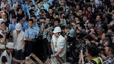 Bailiffs (white hats) remove barricades set up by pro-democracy protesters, under a court injunction in the Mong Kok. Hong Kong’s pro-democracy protesters are at a crossroads as public support fades after nearly two months of glacial traffic and street clashes with activists spliting on whether to retreat or ramp up their campaign. Philippe Lopez / AFP