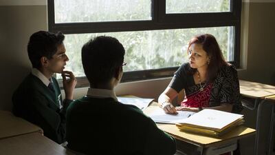 Rachna Prakash, the headmistress at Delhi Private School, discussing about the International Model United Nations conference with pupils Jayesh Kaushik and Manan Lohia. Reem Falaknaz / The National