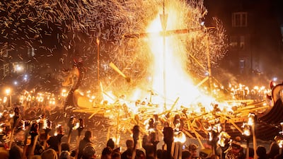 The Jarl Squad throw torches onto a Viking longship during Lerwick’s Up Helly Aa fire festival in Scotland. Getty Images
