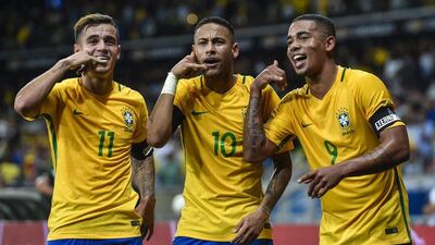 Philippe Coutinho, left, Neymar, centre, and Gabriel Jesus celebrate Brazil's second goal against Argentina. Pedro Vilela / Getty Images