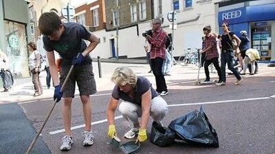 The UK's broom brigade clean up the streets Clapham Junction, south London, of debris following the unrest in London. Paul Ellis / AFP