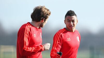MANCHESTER, ENGLAND - FEBRUARY 24: Daley Blind and Jesse Lingard (R) in discussion during a Manchester United training session ahead of their UEFA Europa League round of 32 second leg match against FC Midtjylland at the Aon Training Complex on February 24, 2016 in Manchester, United Kingdom. (Photo by Jan Kruger/Getty Images)