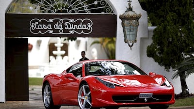A Ferrari is driven away from a home in Brazil. Ueslei Marcelino / Reuters