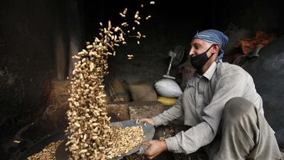 A Pakistani vendor roasts peanuts on a roadside in Peshawar, Pakistan. Bilawal Arbab / EPA