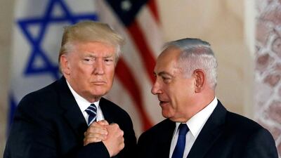 US President Donald Trump and Israeli Prime Minister Benjamin Netanyahu shake hands in 2017. Israel has ramped up construction permits in occupied East Jerusalem by more than 60%. Reuters