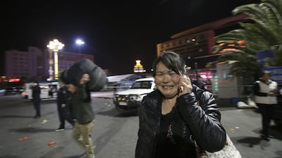 A woman reacts, at the crime scene outside a railway station after a knife attack left scores dead in south China. AP Photo