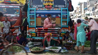 Vendors set up stall before customers arrive at a wholesale vegetable market in the old quarters of Delhi, India. Reuters