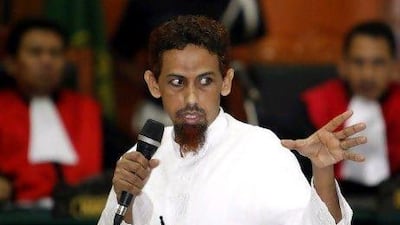 Indonesian terror suspect Umar Patek gestures as he testifies during his trial in Jakarta today.