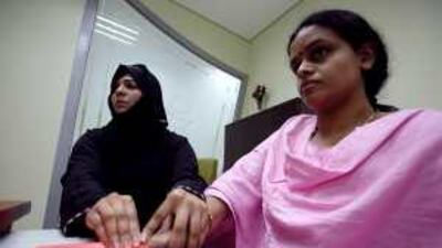 A registration administrator takes finger prints at Emirates Identity Authority registration centre in Dubai.