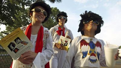 Fans walk down Elvis Presley Boulevard at Graceland in Memphis, Tennessee, in recognition of his death. EPA