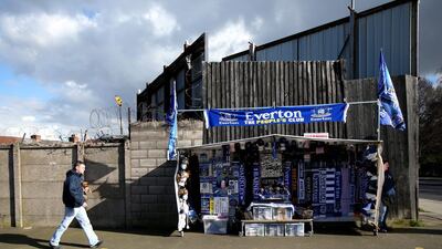 A fan walks past a commercial stand ahead of the match between Everton and West Ham United at Goodison Park on Saturday March 1, 2014. Jan Kruger / Getty Images