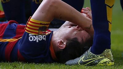 Lionel Messi lies on the pitch after sustaining the injury that is set to rule him out for the next two months. Manu Fernandez / AP Photo
