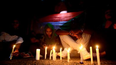 Sudanese protesters take part in a vigil in the capital Khartoum to mourn dozens of demonstrators killed last month in a brutal raid on a Khartoum sit-in, on July 13, 2019. AFP