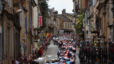 The pelotonrides through the town of Gourdon during Stage 12 of the 111th Tour de France. AFP