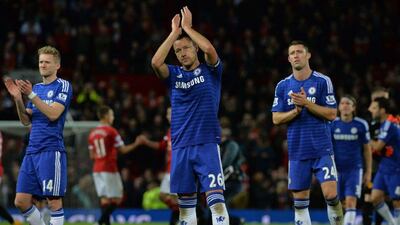 Chelsea's Andre Schurrle, left, John Terry, centre, and Gary Cahill, right, applaud fans after their draw with Manchester United on Sunday at Old Trafford in the Premier League. Paul Ellis / AFP / October 26, 2014