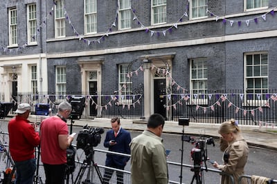 Members of the media wait outside of 10 Downing Street on Monday morning. AFP