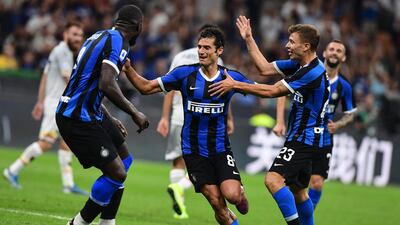 Inter Milan's Italian forward Antonio Candreva celebrates scoring with Romelu Lukaku and Nicolo Barella. AFP