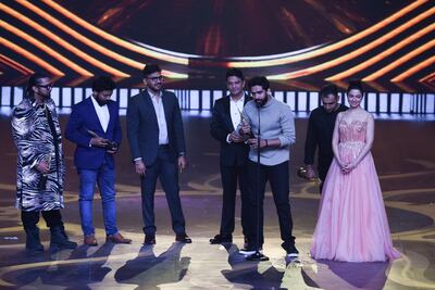 (L-R) Bollywood music directors Honey Singh, Saurabh, Vaibhav, Bhushan Kumar, Amaal Mallik, Rochak Kohli and Divya Khosla Kumar receive the Best Music Direction award for movie 'Sonu Ke Titu Ki Sweety' AFP