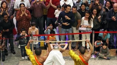 Shoppers watch the Shaolin Monks from China perform at the Mirdif City Centre in Dubai.