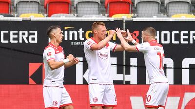 Dusseldorf's Rouwen Hennings, centre, celebrates with teammates after scoring his first goal. EPA
