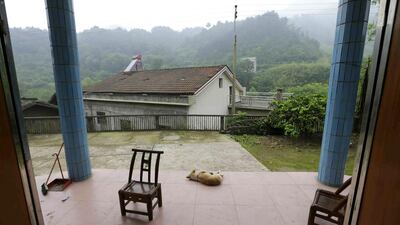 A dog sleeps in front of Wen Jin’e and Xiong Demin’s home at Heshan village, in Shimen county. Wen suffers from cervical cancer and Xiong from lung cancer. Jason Lee / Reuters