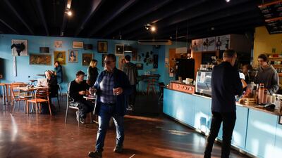 Customers and employees are seen inside a cafe on the first day of all New Zealand domestic regulations being lifted for the coronavirus disease (COVID-19) in Nelson, New Zealand. REUTERS