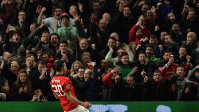 Manchester United's Robin van Persie celebrates scoring his third goal of the game during Wednesday night's victory over Olympiakos at Old Trafford. Paul Ellis / AFP / March 19, 2014