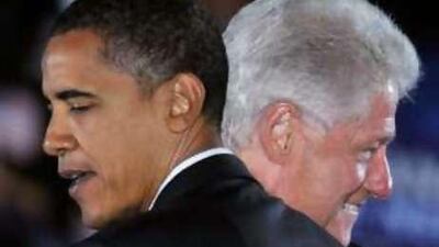 The US president-elect Barack Obama embraces former president Bill Clinton during an October campaign rally.